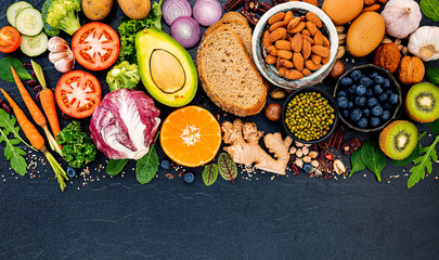 Ingredients for the healthy foods selection. The concept of healthy food set up on dark stone background.