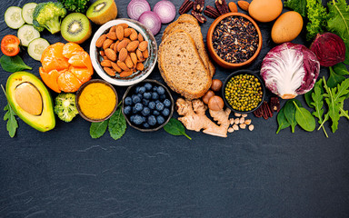 Ingredients for the healthy foods selection. The concept of healthy food set up on dark stone background.