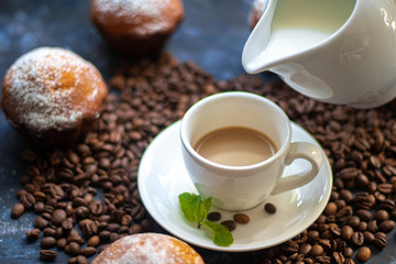 cup of coffee with beans and cinnamon