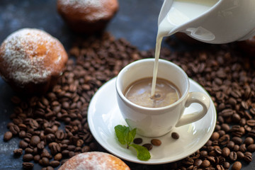 cup of coffee and beans on wooden table