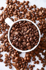 Fototapeta premium Coffee beans in a cup viewed from above. Top view