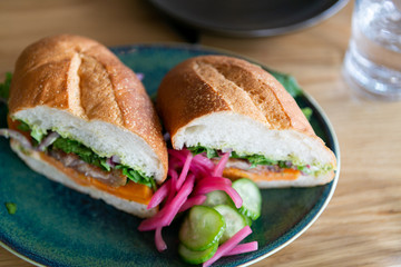 close up of mexican torta sandwich on table at restaurant