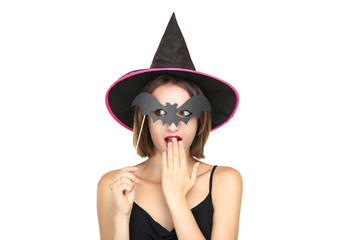 Happy young woman in black halloween costume with paper bat on white background