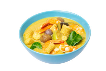 Closeup plate of thailand green curry soup with coconut milk and shrimps isolated at white background.