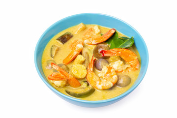 Closeup plate of thailand green curry soup with coconut milk and shrimps isolated at white background.