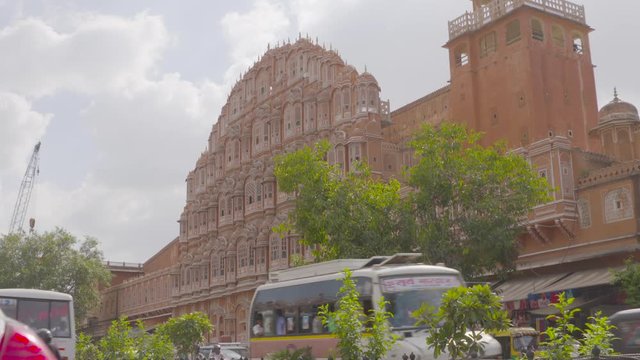 A steady wide shot of the exterior facade of Hawa Mahal (The Palace of Winds) made with red and pink sandstone, located in Jaipur, India.