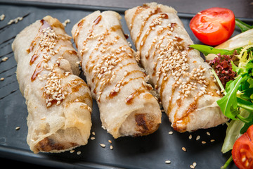 Homemade hot dog wraps in pita on black background