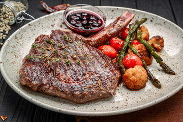 Grilled meat and vegetables on rustic wooden table