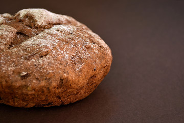 Whole grain rye bread, isolated on dark background. Closeup