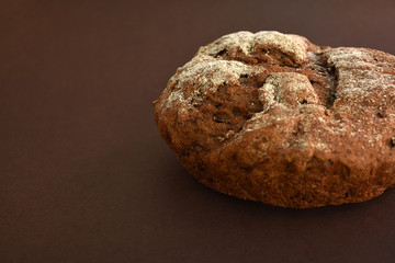 Whole grain rye bread, isolated on dark background. Closeup