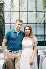 Summer love story in a beautiful interior. Happy smiling couple in the restaurant.