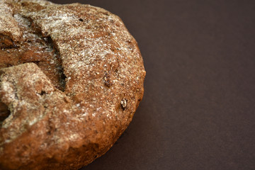 Whole grain rye bread, isolated on dark background. Closeup