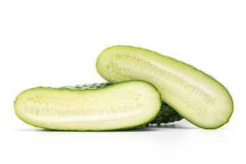 Group of two halves of fresh pickling cucumber isolated on white background