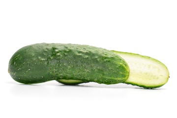 Group of two halves of fresh pickling cucumber one cut isolated on white background
