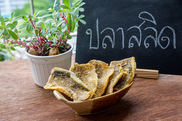 Fried Trichogaster pectoralis cut in slice fry for crispy on wooden background, Salid fish thai...
