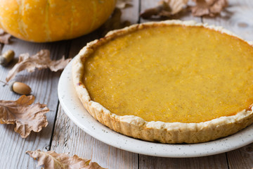 Pumpkin pie on wooden table