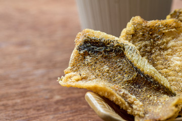 Fried Trichogaster pectoralis cut in slice fry for crispy on wooden background, Salid fish thai food