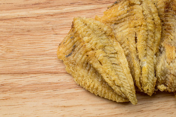 Fototapeta na wymiar Fried Trichogaster pectoralis cut in slice fry for crispy on wooden background, Salid fish thai food