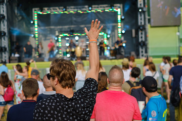 Couple is watching concert at open air music festival