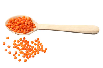 red lentils in wooden spoon isolated on white background. Top view.