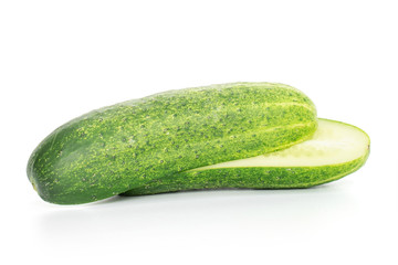 Group of two halves of fresh green pickling cucumber one cut isolated on white background