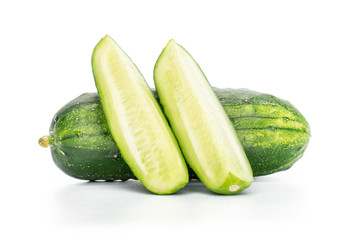 Group of one whole two slices of fresh green pickling cucumber isolated on white background