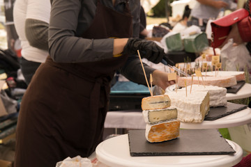 Woman Serving Fresh Cheese At Farmers Food Market