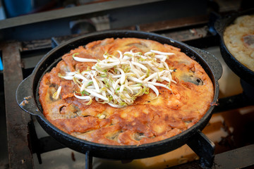 Crispy fried mussels with egg hot pan, street food Thailand