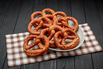 Fresh bavarian pretzels on a wooden table, pretzel with salt