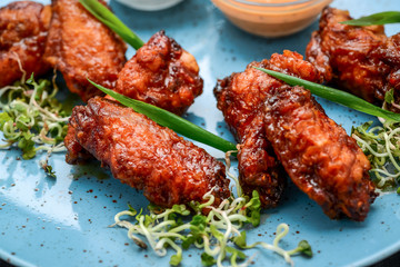 Baked chicken wings in the Asian style on plate