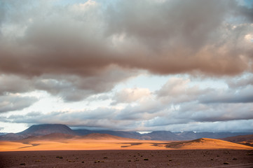 Fototapeta na wymiar Volcanos, lagunas and desert of Atacama Desert. Mountains southern and northern from San Pedro de Atacama. Stunning scenery in sunlight at Atacama desert, Chile, South America