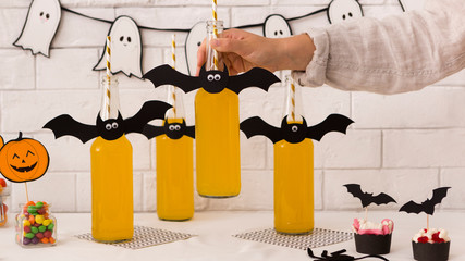 Halloween beer in glass bottles with paper bats on the top