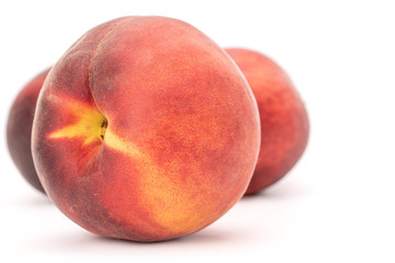 One whole pink fresh fuzzy peach isolated on white background