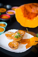 baked sweet pumpkin muffins with dried apricots inside
