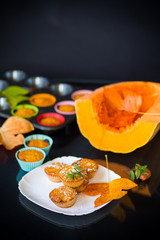 baked sweet pumpkin muffins with dried apricots inside