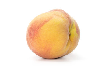 One whole yellow fresh fuzzy peach isolated on white background