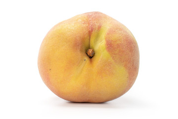 One whole fresh fuzzy peach with blush isolated on white background