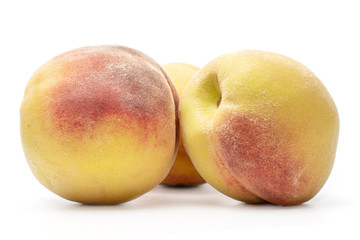 Group of three whole bright fresh fuzzy peach isolated on white background