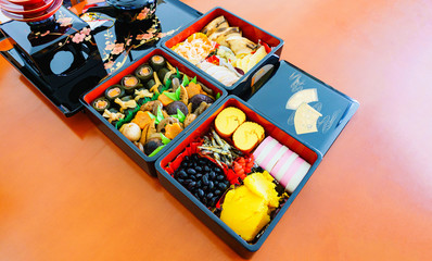 Obraz na płótnie Canvas Japanese handmade new year dishes named Osechi-Ryori in the traditional box