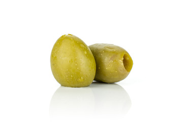 Group of two whole small pitted green olive isolated on white background