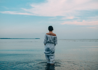 brunette woman dress goes water sea color sky