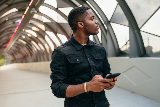 Man with mobile phone looking aside