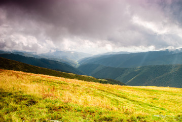 Fall landscape in the mountains, cloudy and sunghine