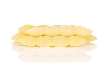 Lot of whole uncooked pasta cavatelli stack isolated on white background