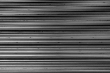 Obraz premium Horizontal corrugated fence of grey metal sheets. Texture of metal fence picket profile decking.