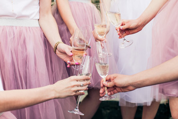 Close view of hands with glasses of champagne
