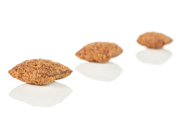 Group of three whole crispy brown cereal pillow placed diagonally isolated on white background