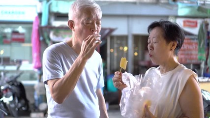 Asian senior couple eating pineapple vitamin tropical fruits