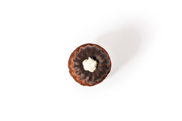 Sweet cookie cake cupcake with vanilla cream and shkoladom. On a white background isolate. A treat for any holiday.