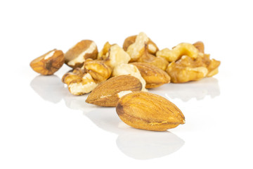Lot of whole brown almond nut heap isolated on white background